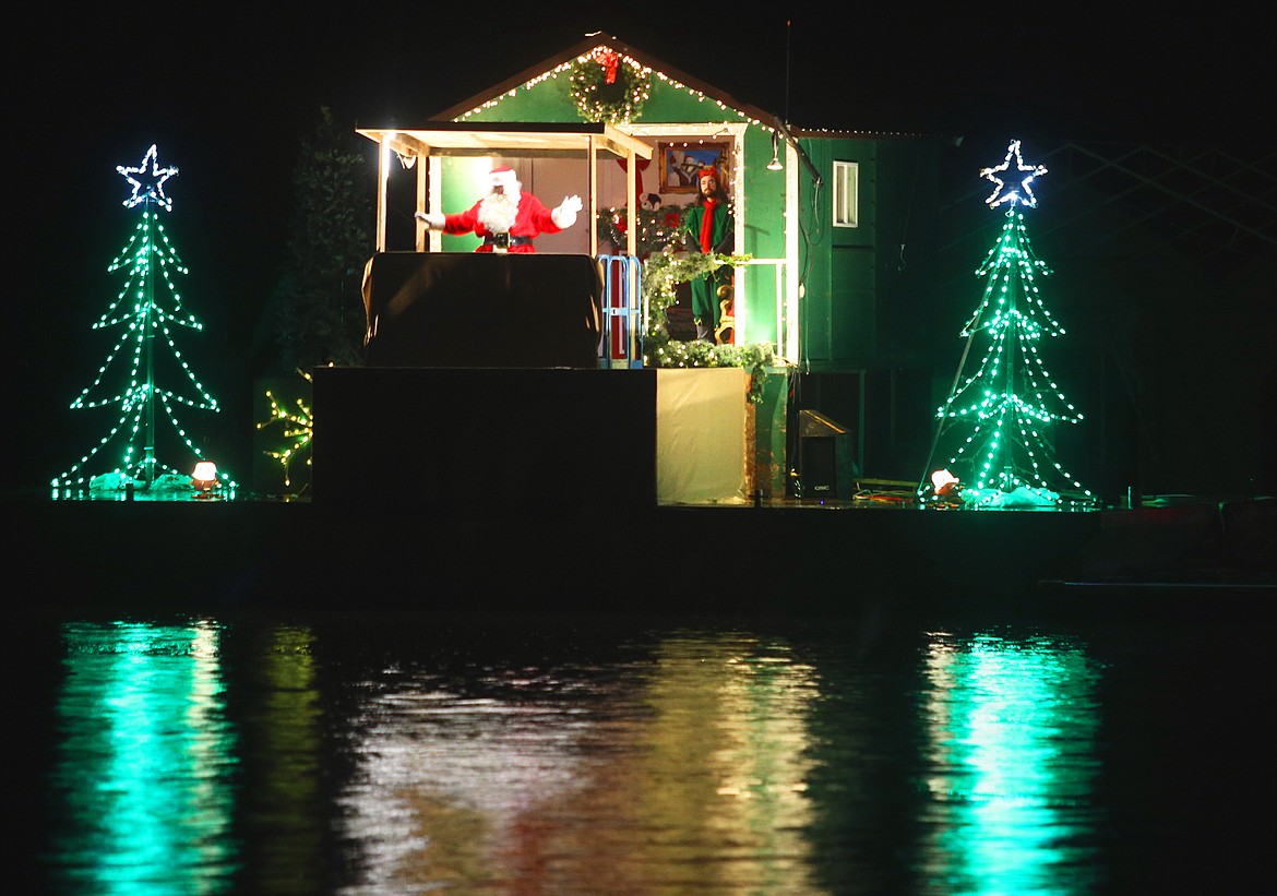 Santa Claus greets guests during their Journey to the North Pole Tuesday night aboard a cruise boat that crossed Lake Coeur d'Alene.