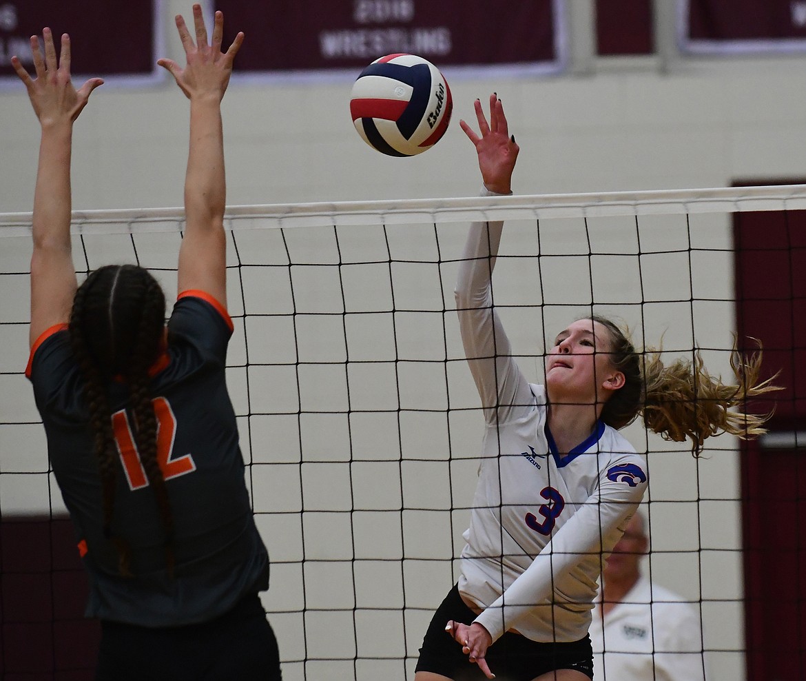 Dillen Hoerner taps the ball over the net against Hardin Thursday night during the second round of playoffs at the state tournament in Sidney. (Teresa Byrd/Hungry Horse News)