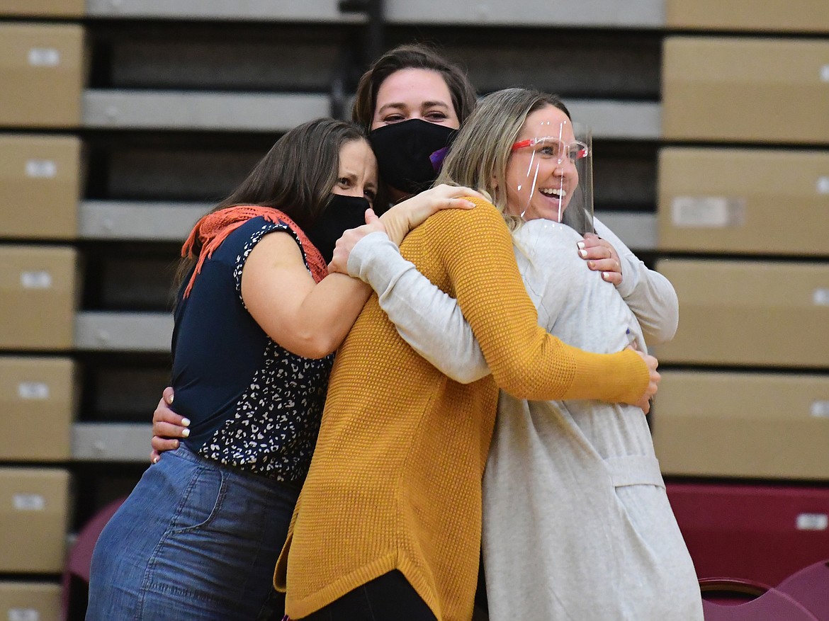 The Wildkat volleyball coaches huddle in a celebratory hug after the Kats came back to beat Hardin which landed them in the championship match. (Teresa Byrd/Hungry Horse News)