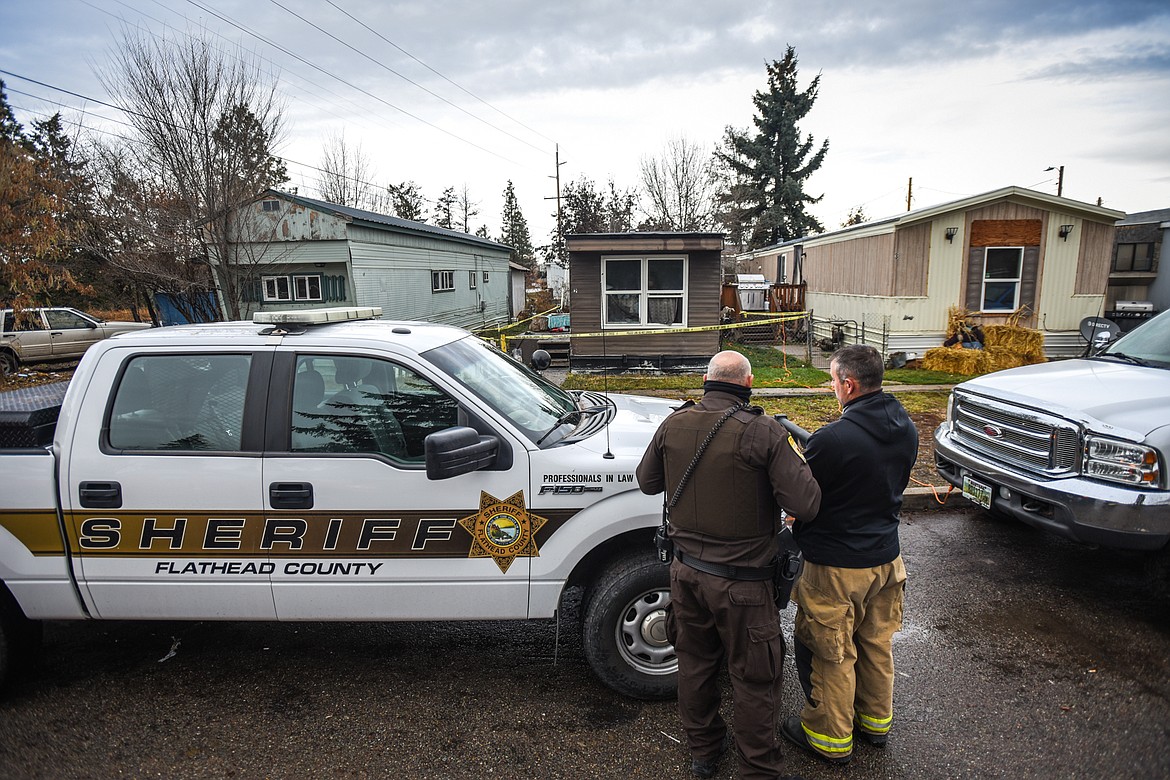 Investigators stand at the scene of a fatal house fire on East California Street in Kalispell on Wednesday, Nov. 18. (Casey Kreider/Daily Inter Lake)