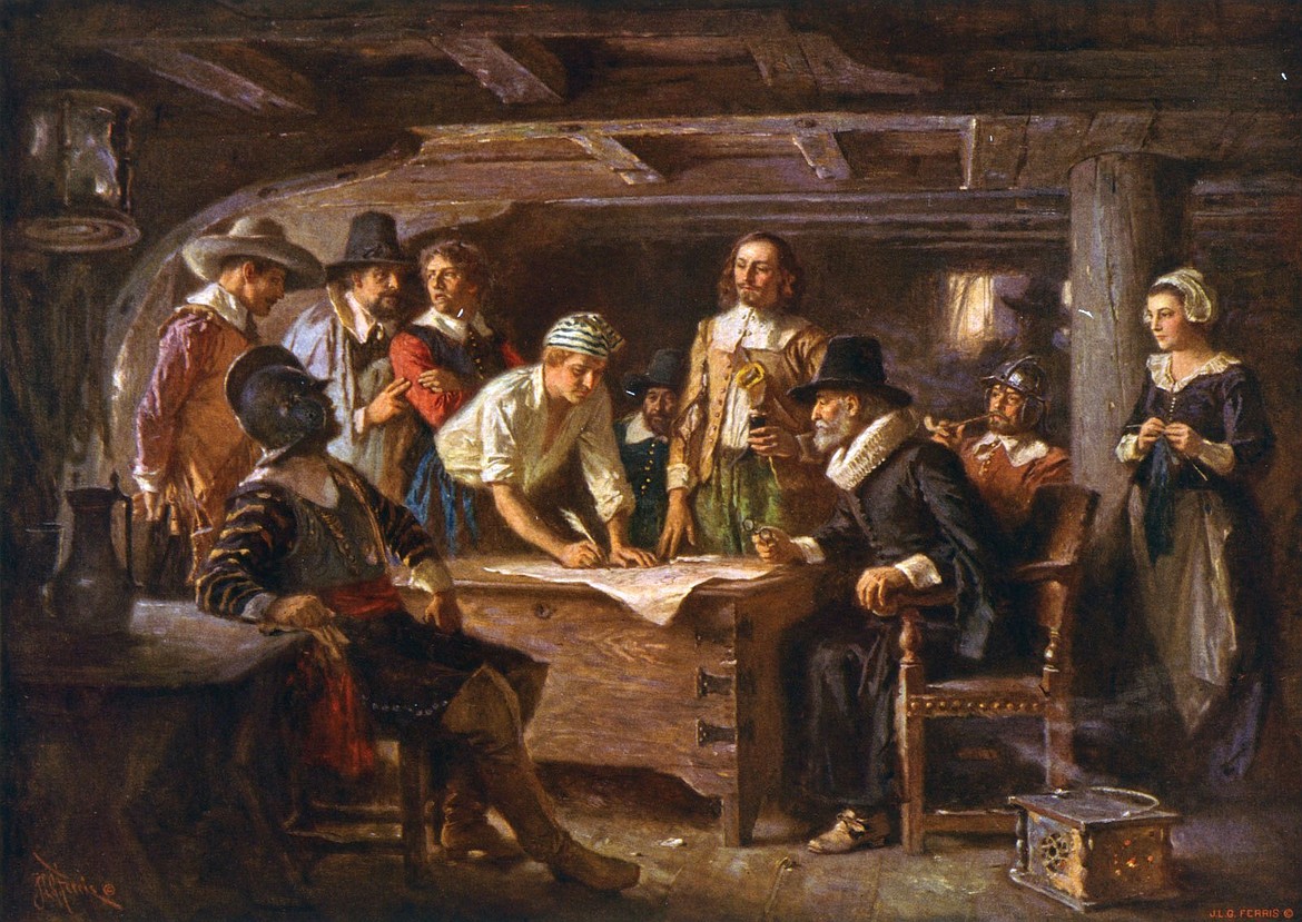 Signing the Mayflower Compact, America’s first governing document, aboard the ship Mayflower before going ashore (Nov. 11, 1620).