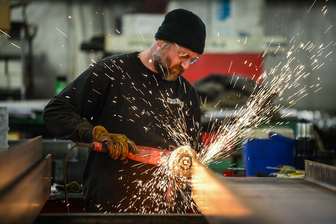 A worker grinds a steel beam at a workstation at Acutech Metalworks on Wednesday, Nov. 18. (Casey Kreider/Daily Inter Lake)