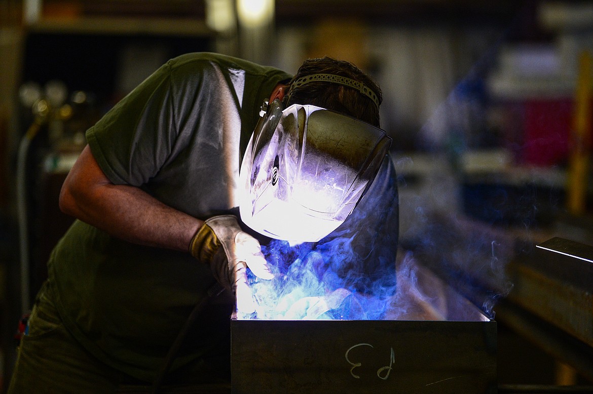 A welder works at a workstation at Acutech Metalworks on Wednesday, Nov. 18. (Casey Kreider/Daily Inter Lake)
