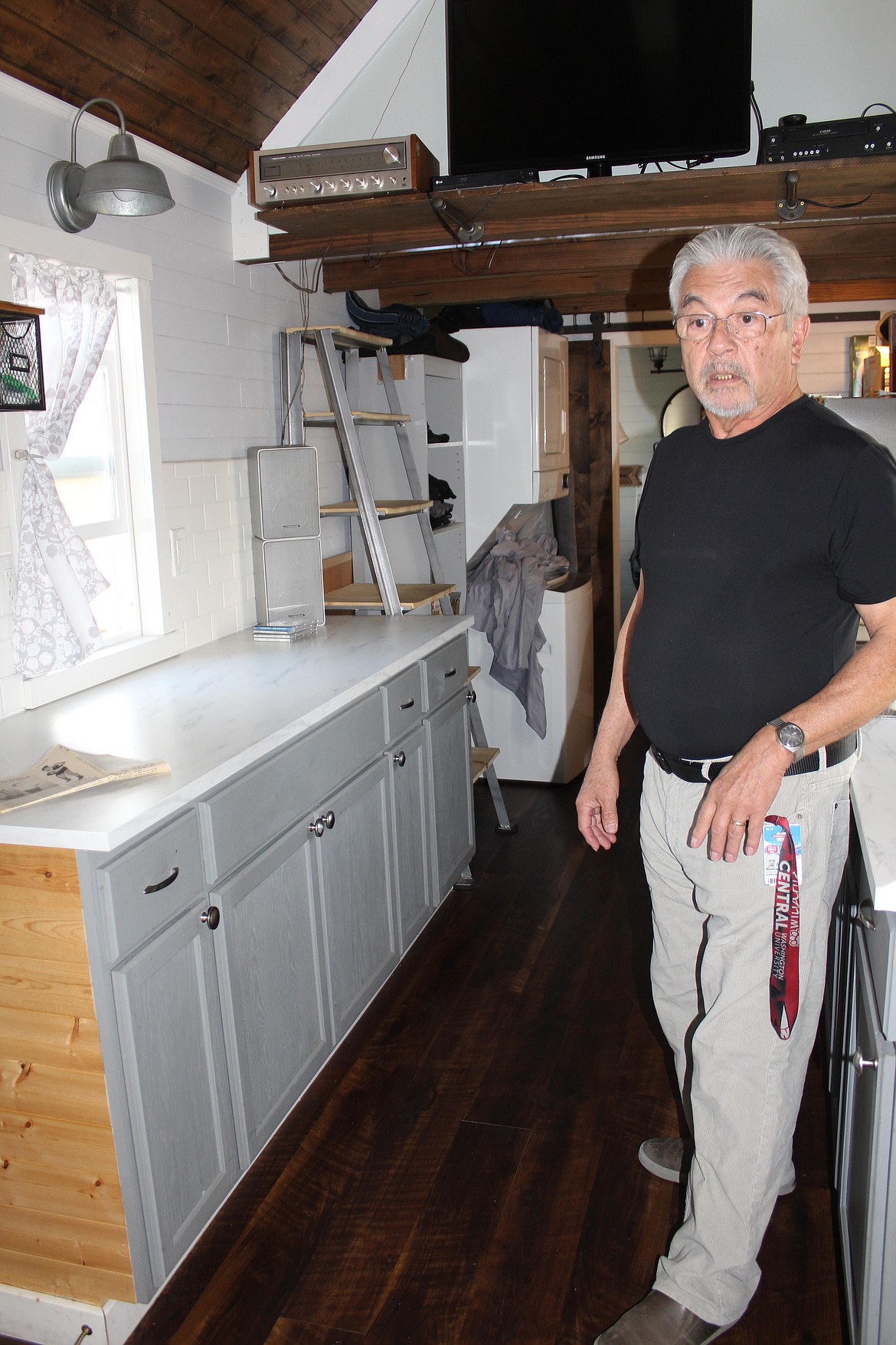 Rudy Herrera stands in his tiny home in Quincy.