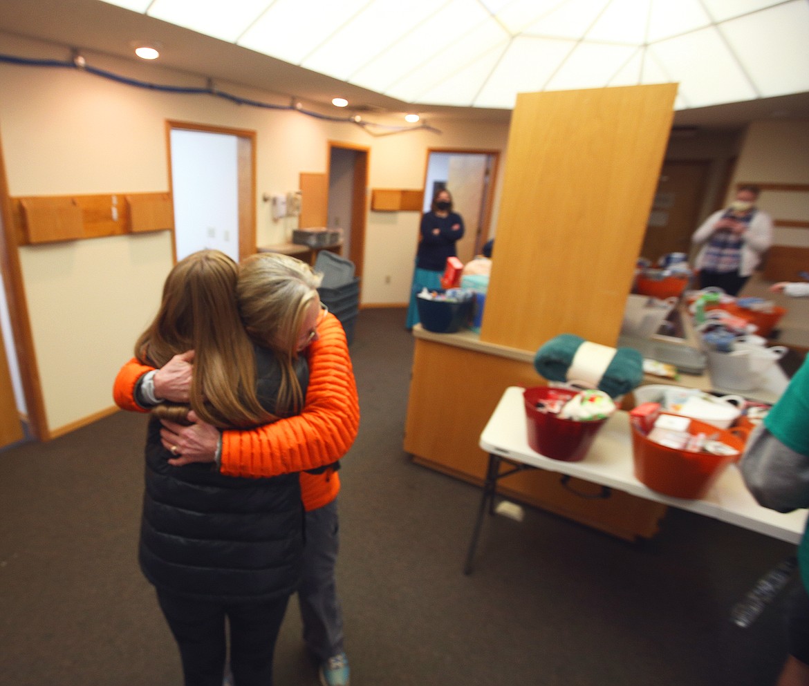 Kootenai Health nurse Sandra Dolyniuk hugs Post Falls High School student Reagan Hartzell as she and classmates delivered gifts to the testing center Friday morning.