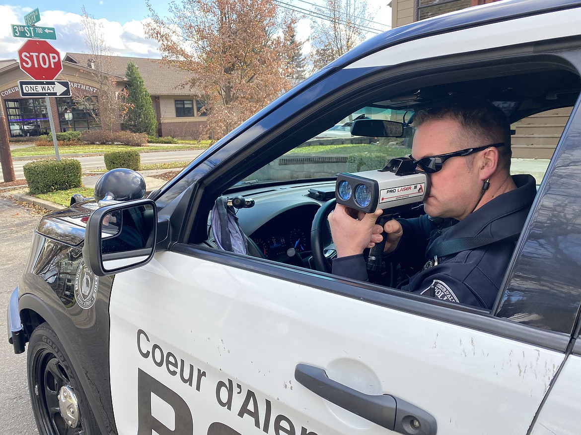 Officer Anthony Tenney from the Coeur d'Alene Police Department traffic team was out eyeing drivers downtown on Third Street Friday as part of the nationwide seatbelt initiative. (MADISON HARDY/Press)