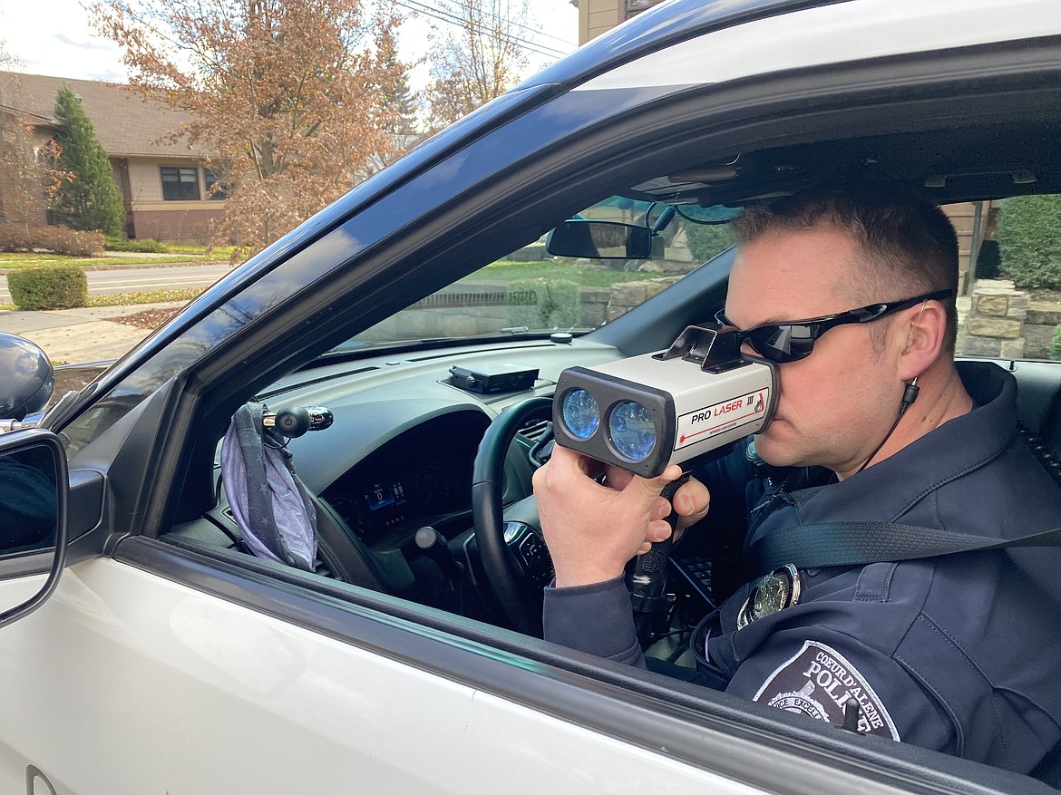 Officer Anthony Tenney from the Coeur d'Alene Police Department traffic team was out eyeing drivers downtown on Third Street Friday as part of the nationwide seatbelt initiative. (MADISON HARDY/Press)