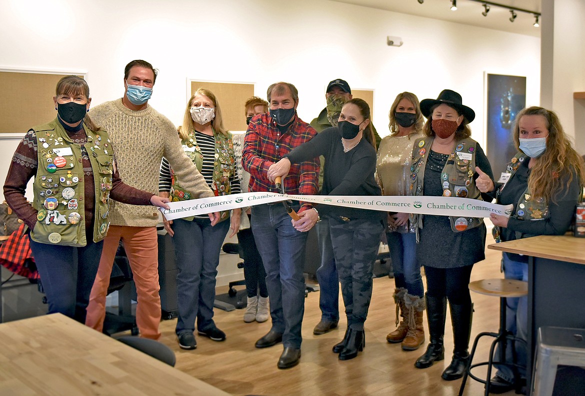 The owners of the new business CoWorking on Central celebrate their opening with the Whitefish Chamber of Commerce and some friends at a ribbon cutting ceremony Thursday afternoon. (Whitney England/Whitefish Pilot)