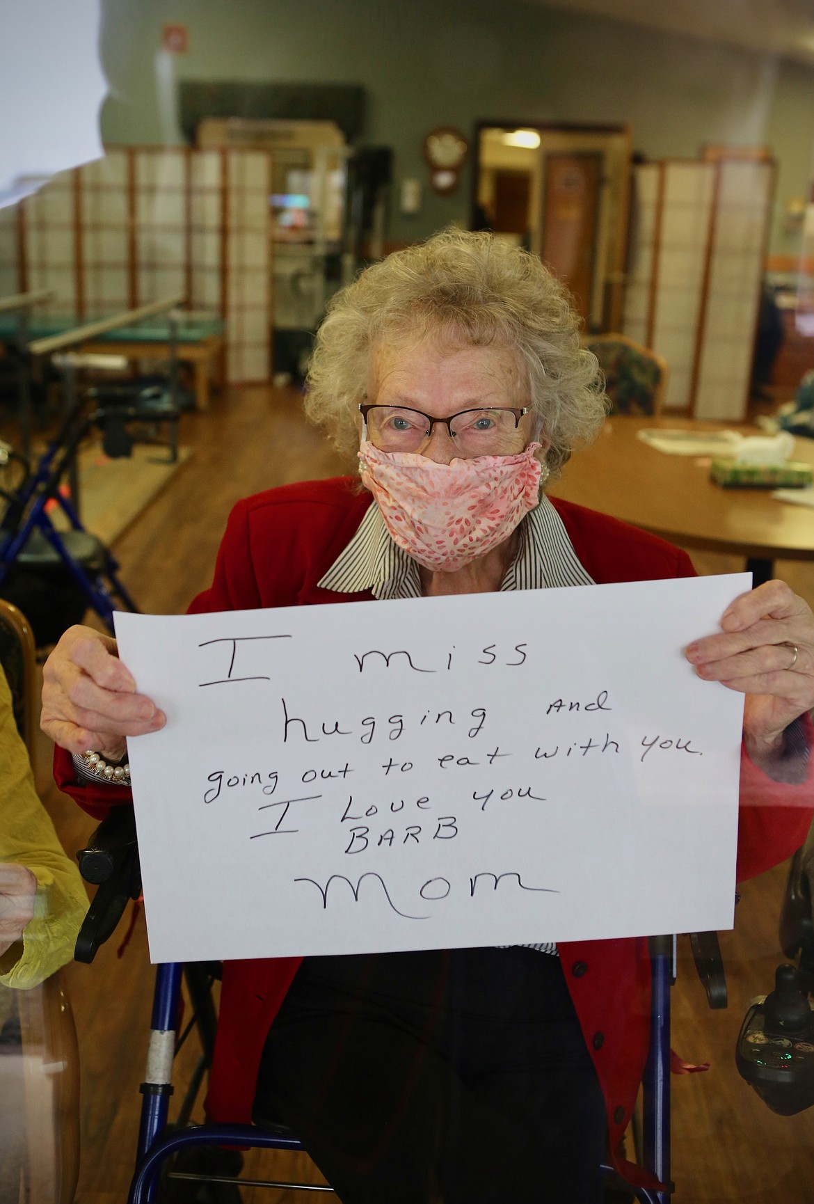 Mackenzie Reiss/Bigfork Eagle
Lake View Care Center resident Kay Walsh, 96, poses with a sign she made for her daughter that read: "I miss hugging and going out to eat with you. I love you Barb, - Mom."