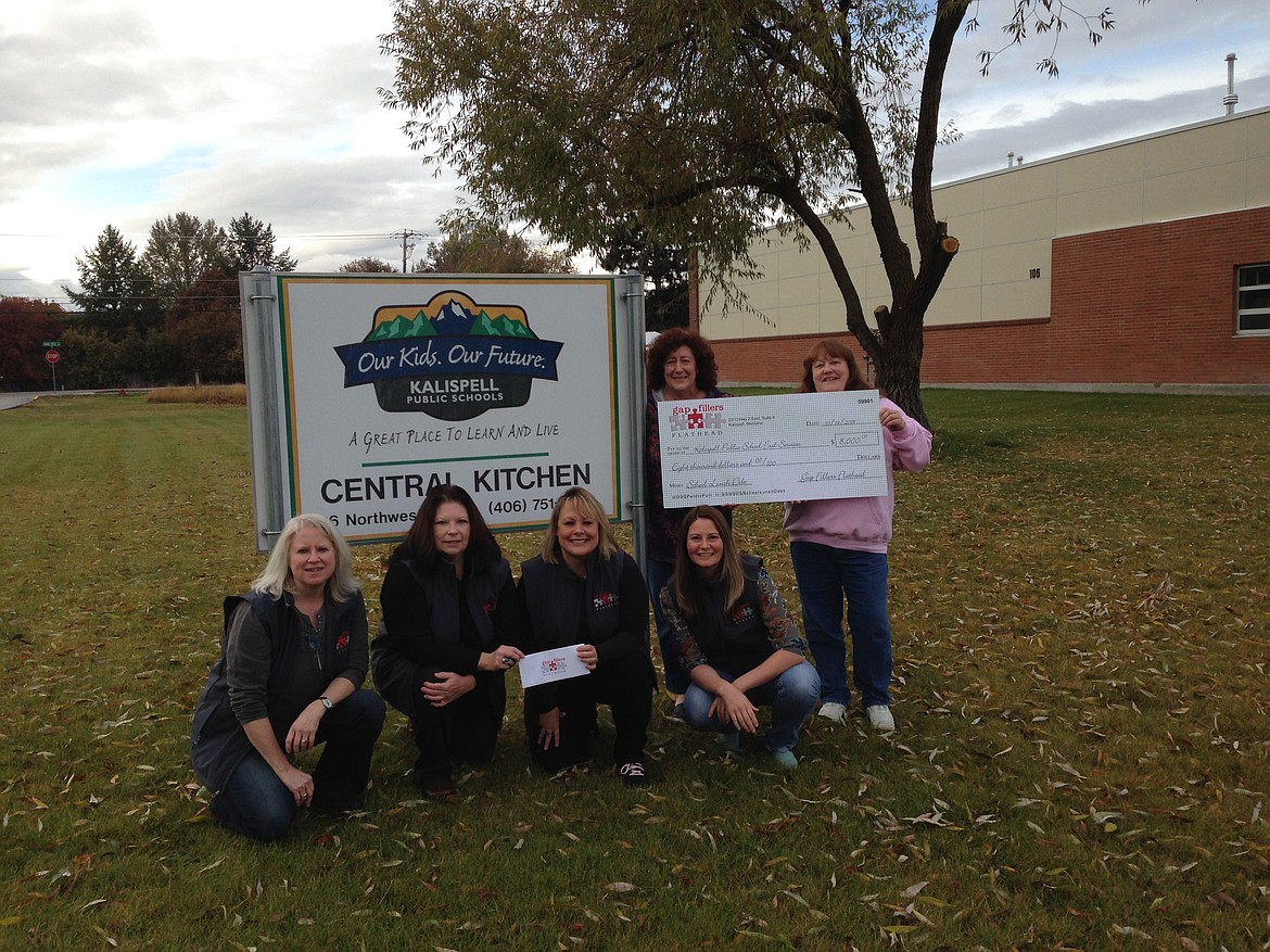 Paying off lunch debt is one initiative of Gap Fillers Flathead. From left to right, Gap Fillers Flathead board members: Mickey Lapp, Dee Kirk-Boon, Tammi Fisher and Sarah Stahlberg with Kalispell Public Schools food service staff members. Board members not pictured include Michele Paine and Jeanne Parker. (Photo provided by Gap Fillers Flathead)