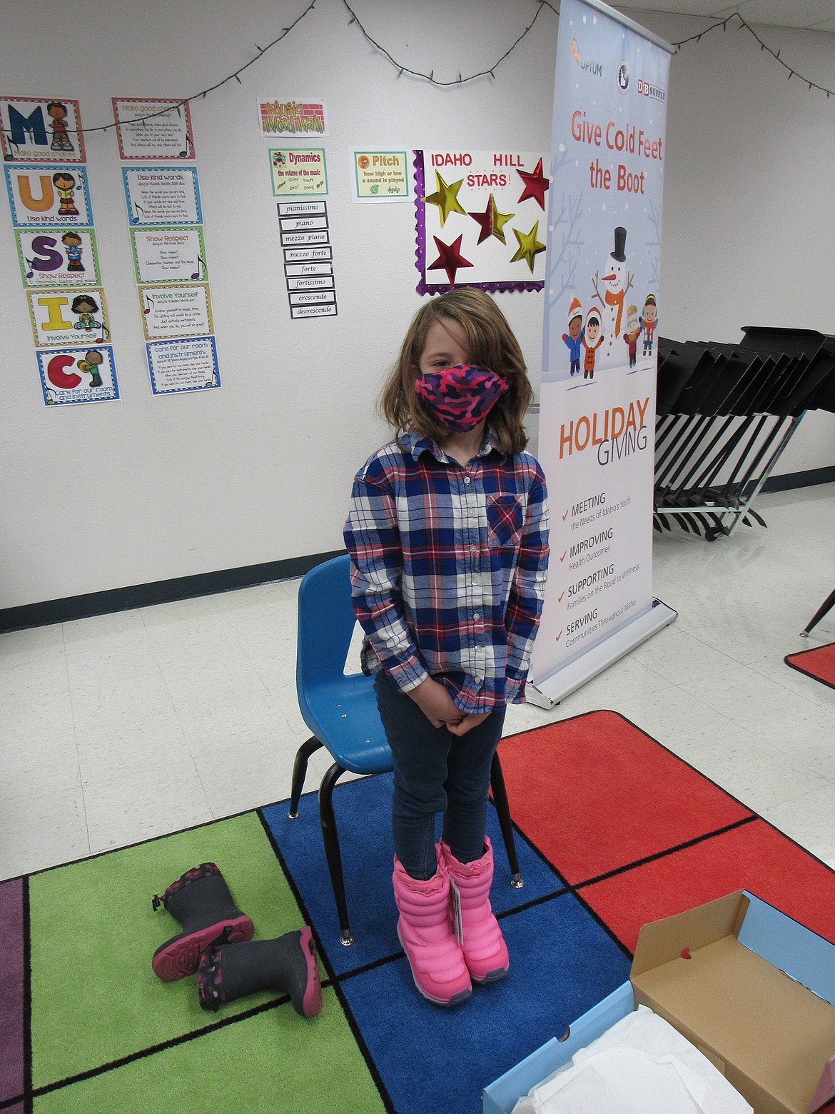 An Idaho Hill Elementary student takes her new boots for a test drive at last week's "Give Cold Feet the Boot" campaign, in which eight schools in the state, including the Oldtown school, received a new pair of winter boots for each student.