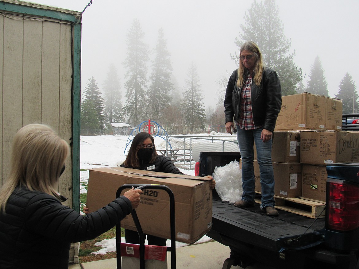 "Give Cold Feet the Boot" organizers and Idaho Hill Elementary staff unload winter boots from a truck so that they can be to every student at the school. The boots and a pair of warm winter socks were given to Idaho Hill students on Nov. 16.