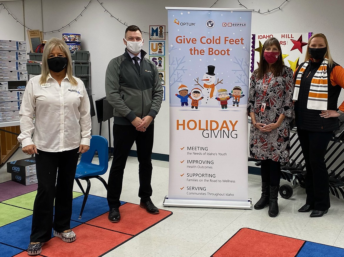 Optum Idaho, Idaho State Department of Education, North 40 Outfitters and Idaho Hill staff pose for a photo at last week's "Give Cold Feet the Boot" campaign during which every child in the school were given a new pair of winter boots.