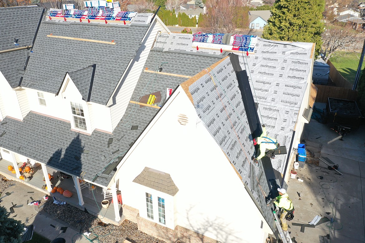 Workers with Royal Roofing Inc. install a new roof on a house in Eastern Washington.