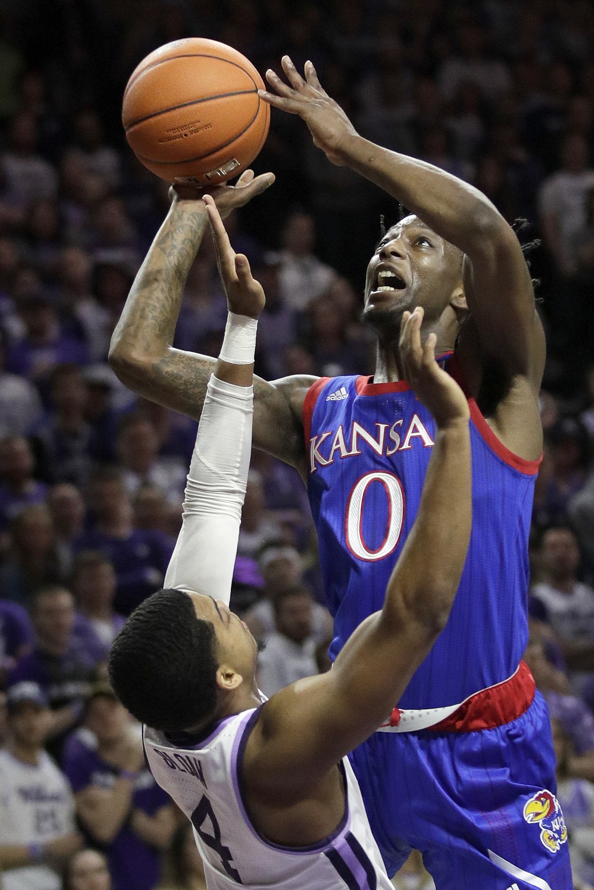 ORLIN WAGNER/Associated Press
Kansas guard Marcus Garrett (0) shoots over Kansas State guard David Sloan (4) in a Feb. 29 game in Manhattan, Kan.