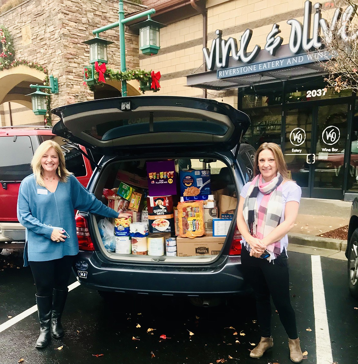 Keeping to tradition, Vine & Olive Eatery and Wine Eatery donated bags of goodies to the St. Vincent De Paul Father Bill's Kitchen in honor of their anniversary and the season of giving. Photo courtesy Larry Riley, St. Vincent De Paul.