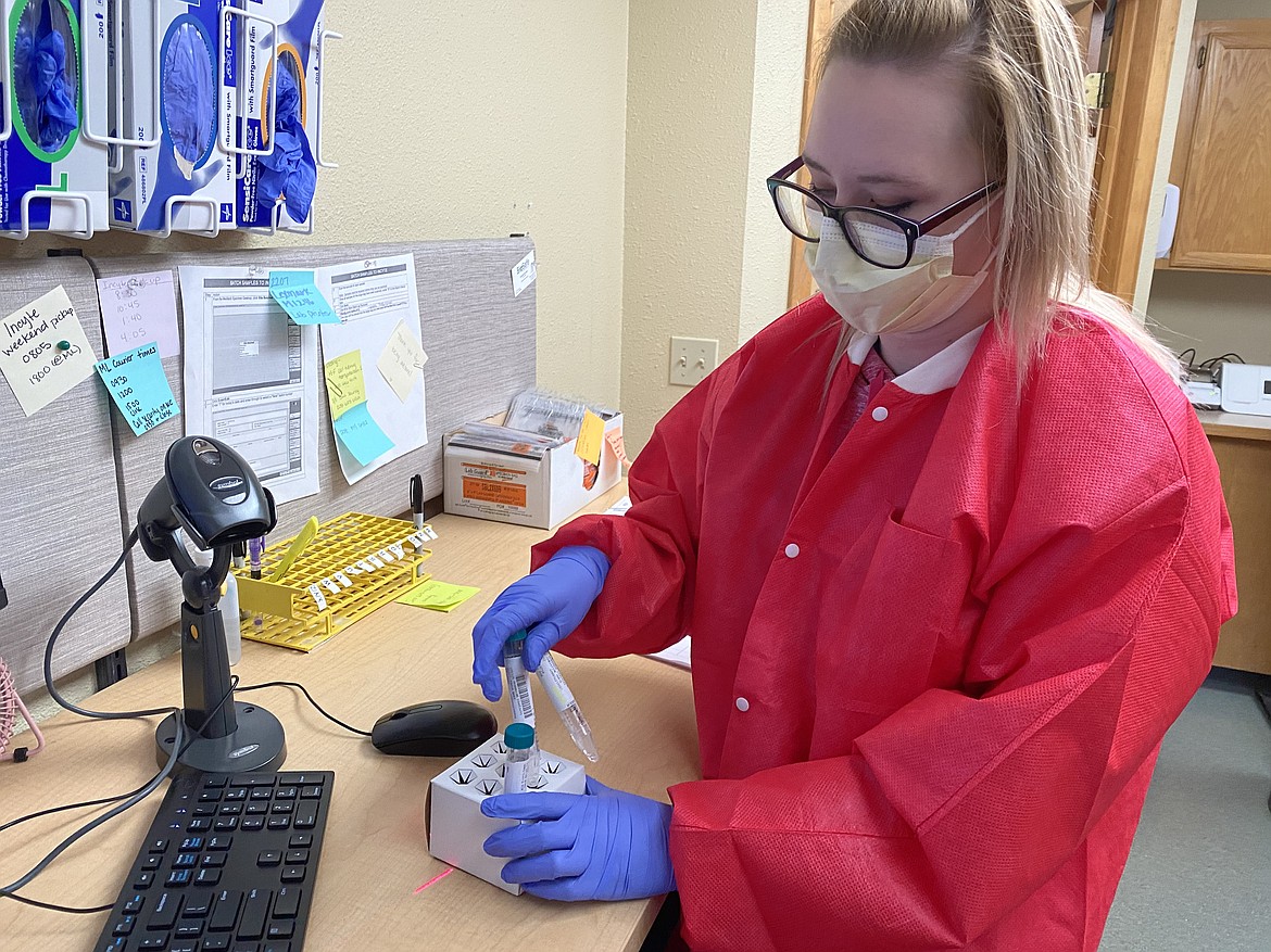 Lab assistant Teata Montgomery processes and logs test results from the Kootenai Health Testing Center from its 7 a.m. open to 5 p.m. close everyday. (MADISON HARDY/Press)