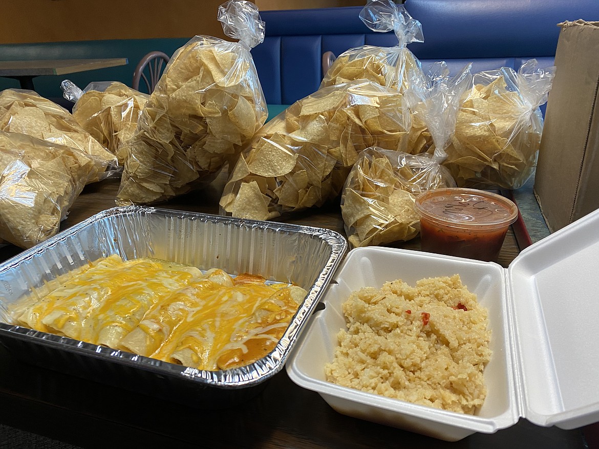 Families that went through El Ranchero on Thursday were served up a heaping amount of chicken, and ground or shredded beef enchiladas, rice and beans. (MADISON HARDY/Press)