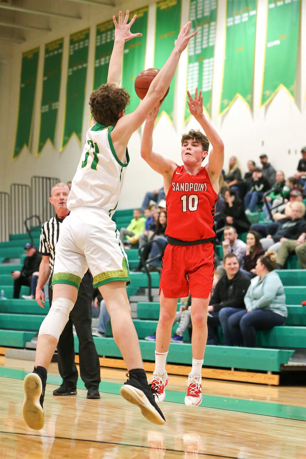 Arie VanDenBerg (right) fires a 3-pointer over a Lakeland defender last season. The sophomore is a team captain and one of the Bulldogs' key returners.