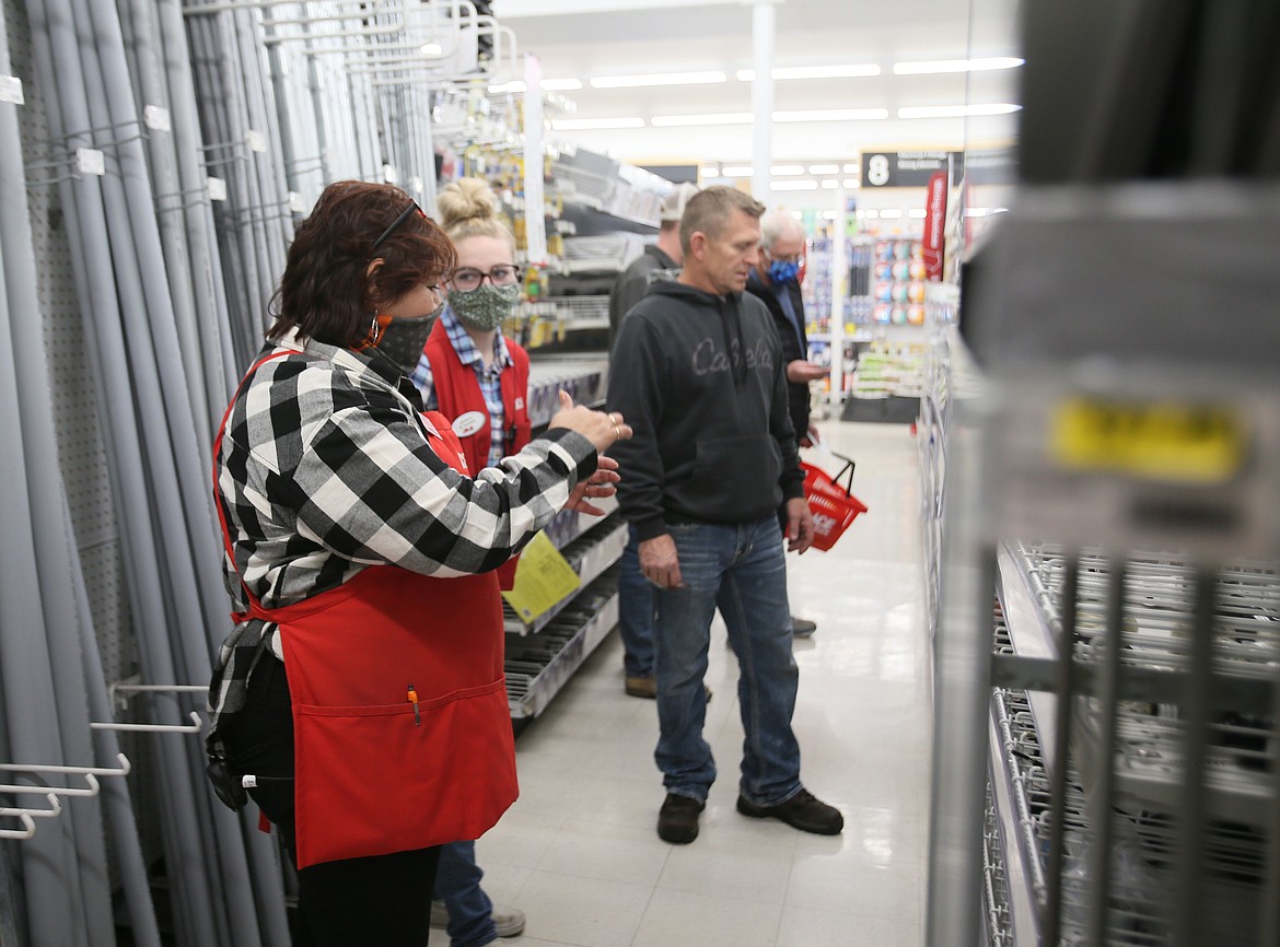 Coeur d'Alene Seright's Ace Hardware store employees Esther Delcomte, left, and Kelsey McKracken on Wednesday assist Chad Owens of Coeur d'Alene in his search for a piece of hardware. Seright's introduced free or low cost local delivery in 2019 and has offered “buy online, pickup in store” for a number of years, giving it an advantage when the pandemic struck.