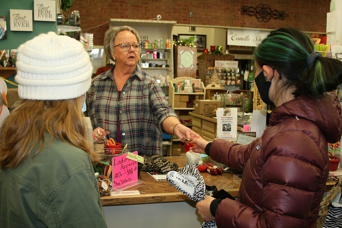 Sue's Gift Boutique owner Sue Torrence (Center) chats with customers Clara Knapp (right) and Matti Curtis (left) on Small Business Saturday. Torrence said the day produced a steady stream of customers.