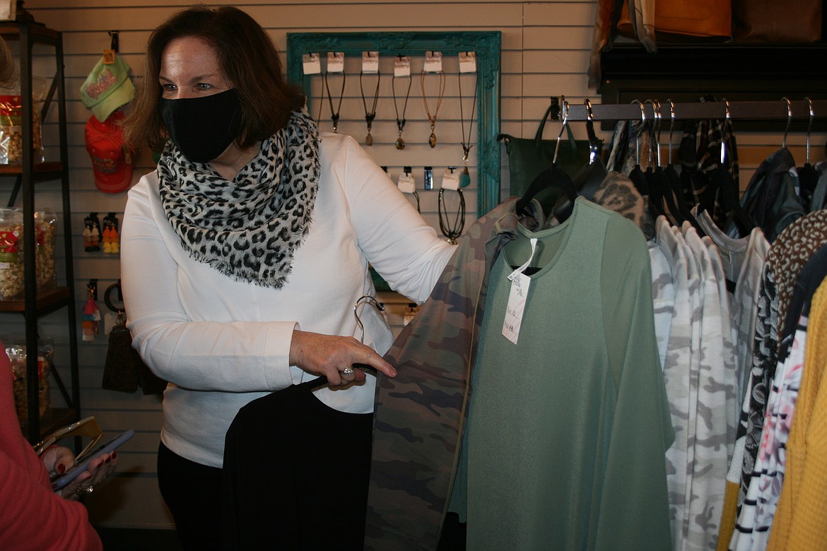 Doris Rosenow of Stella & Me helps a customer coordinate the different pieces of a gift on Small Business Saturday.