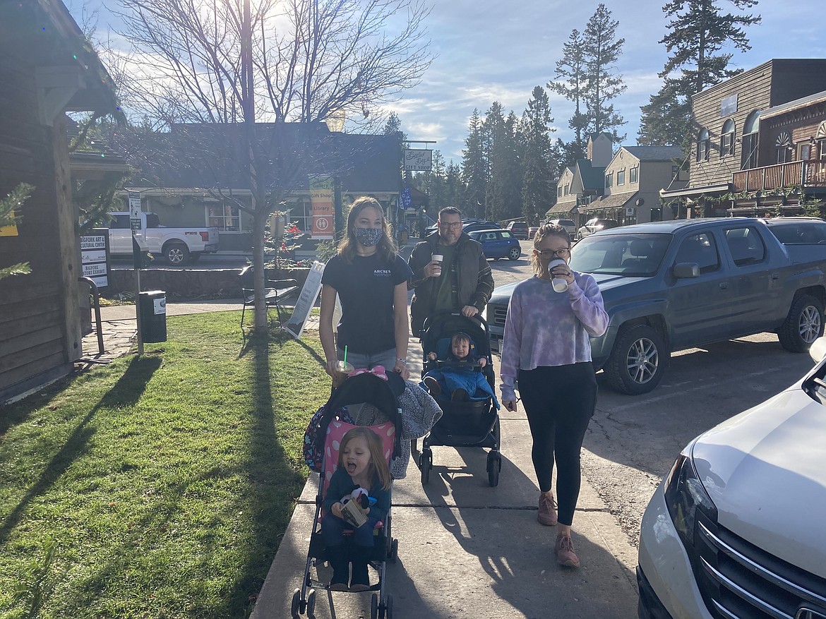 Bret Serbin/For the Eagle
Family members take a holiday visitor on a stroll down Electric Avenue in Bigfork on Black Friday. From left: Kendall Pyron, Ophelia Holsapple (in stroller), Scott Pyron (of Mississippi), Maddox Holsapple (in stroller) and Allie Holsapple.