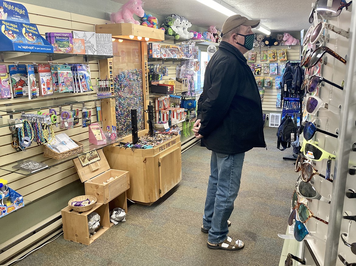 Bret Serbin/For the Eagle
Daniel Brew browses the shelves at Bigfork Bay Gift and Gear.