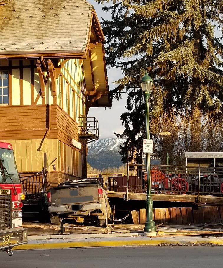 The driver of a pickup truck crashed into the Whitefish Depot building Sunday morning heavily damaging the deck around the building. (Courtesy photo)