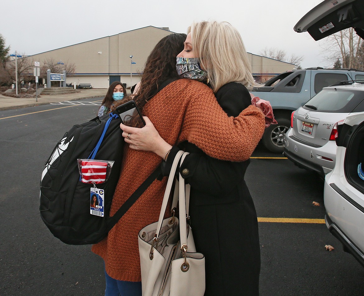 Corinne Weber and Coeur d'Alene High School junior Tianna Harrell exchange a heartfelt hug Monday morning after Tianna shared the story of how her family used a Ronald McDonald House when her baby half-sister was going through treatment before she passed away 15 years ago.