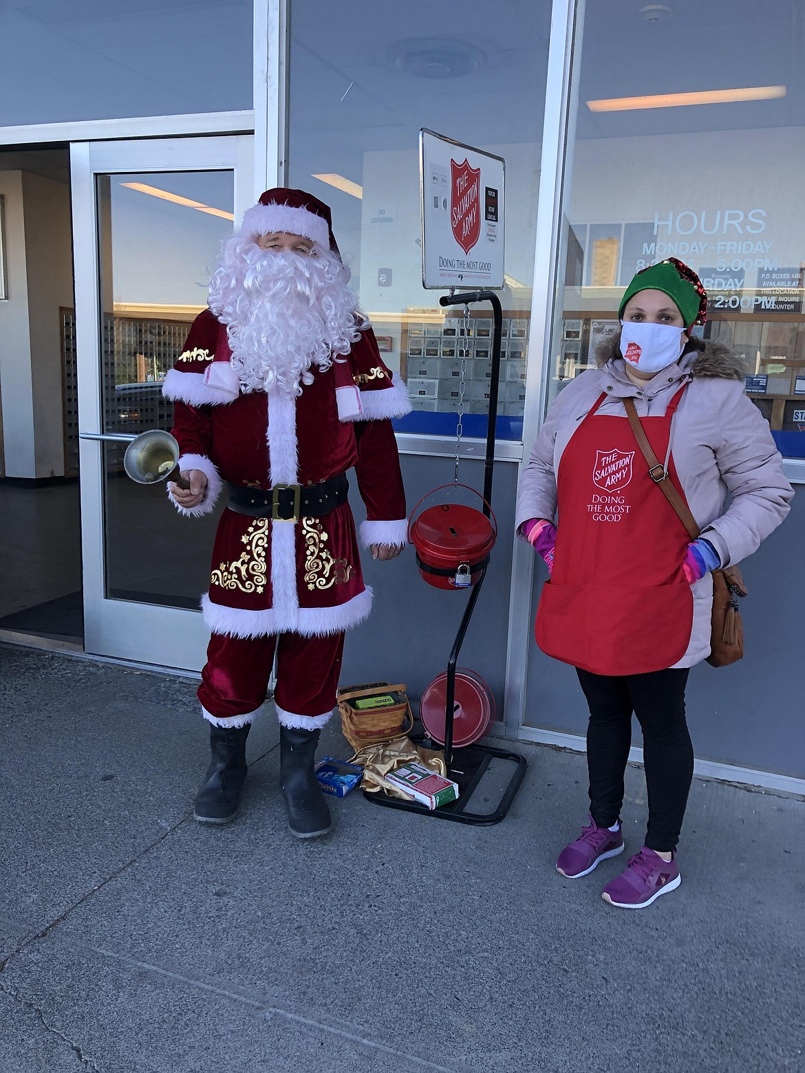 Salvation Army bell ringers Ed MacDonald (left) and Lilia Godinez out in front of the Moses Lake Post Office on Tuesday.
