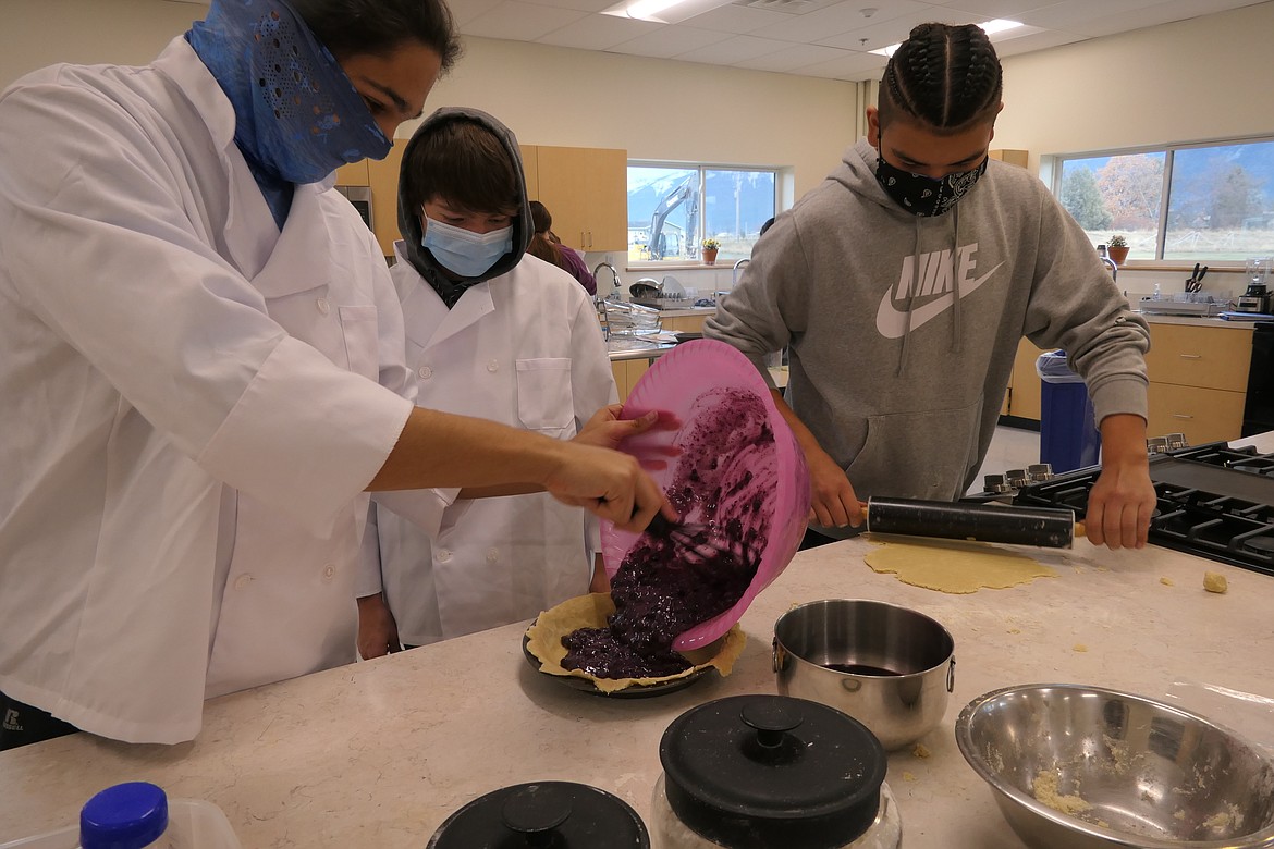 From left, students Erich Morigeau, Zoran Lafrombois and Joseph Weaselhead prepare a blueberry pie in Terry Cable's culinary arts class. (Carolyn Hidy/Lake County Leader)