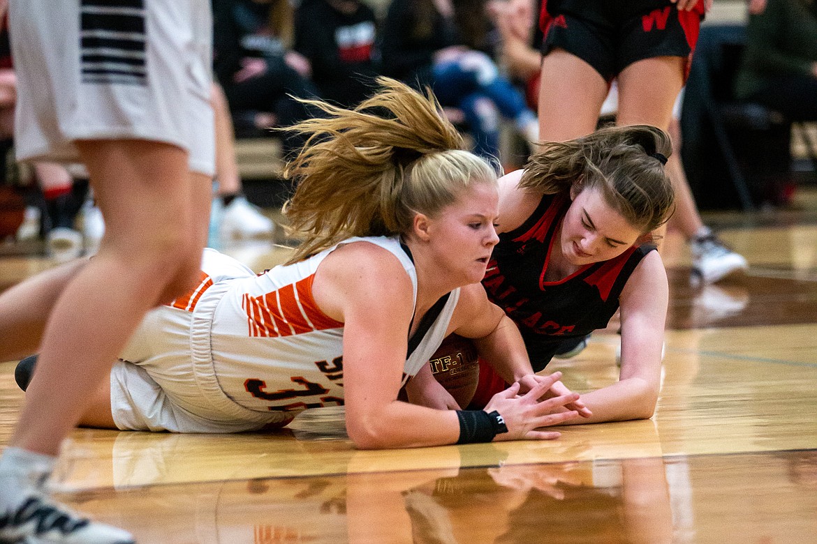 Freshman Allyson Barton dives on the floor to fight for a loose ball during Wednesday's game.