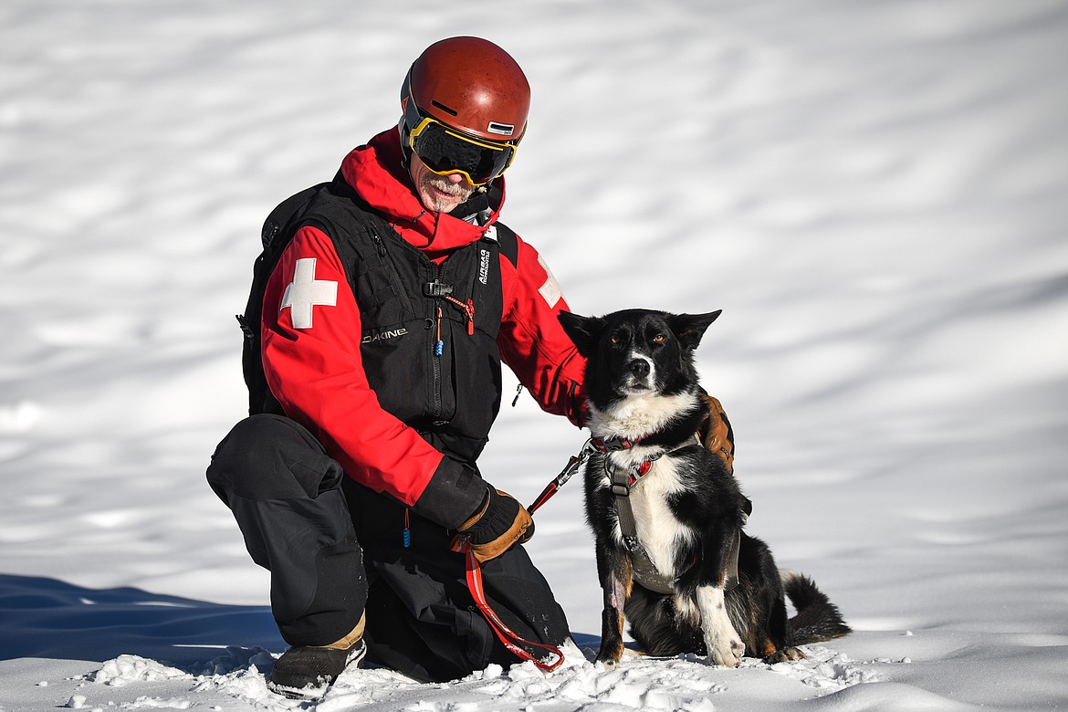 Jett and owner Lloyd Morsett, a snow safety coordinator for Whitefish Mountain Resort ski patrol, pose outside the resort on Wednesday, Dec. 3. Jett, an avalanche rescue dog, was diagnosed with B-cell lymphoma after  Morsett found a lump on Jett’s neck. (Casey Kreider/Daily Inter Lake)