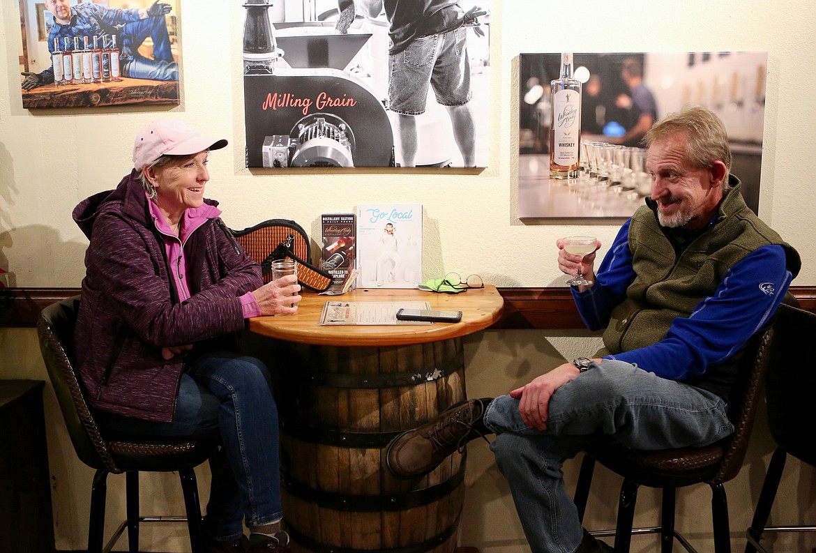 Mackenzie Reiss/Bigfork Eagle Tauni O'Brien, of Bigfork, enjoys a drink with Trevor Brenton, of Boise, Idaho on Monday evening at Whistling Andy Distillery.