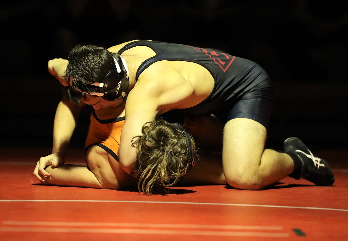 Senior Isaac Webb (top) prepares to pin Priest River's Matyus McLain during a 170-pound bout on Friday night.