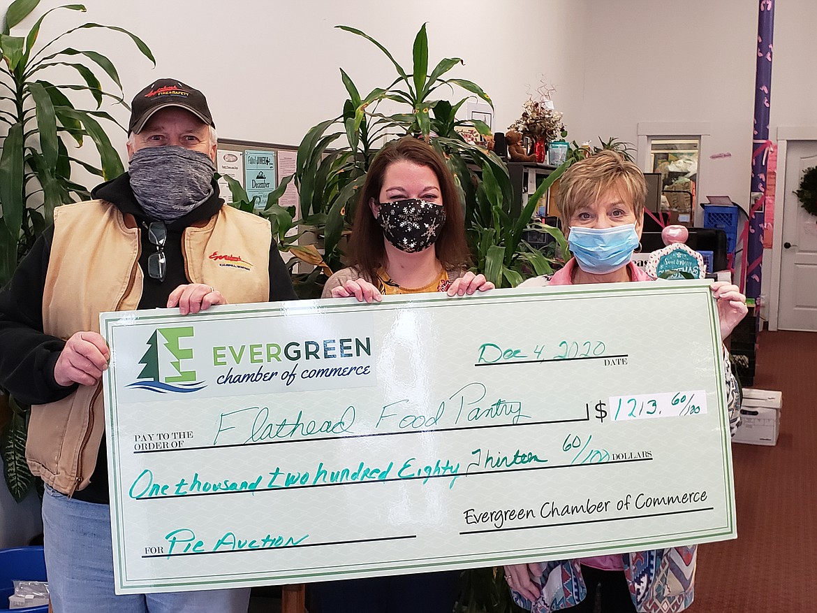 Gary Mahugh, president of the Evergreen Chamber of Commerce, and Connie McCubbins, Chamber executive director, present Jamie Quinn, (center), executive director of the Flathead Food Bank, with a $1,213.60 donation as a result of proceeds from the Chamber's annual pie auction, together with donations from the community.