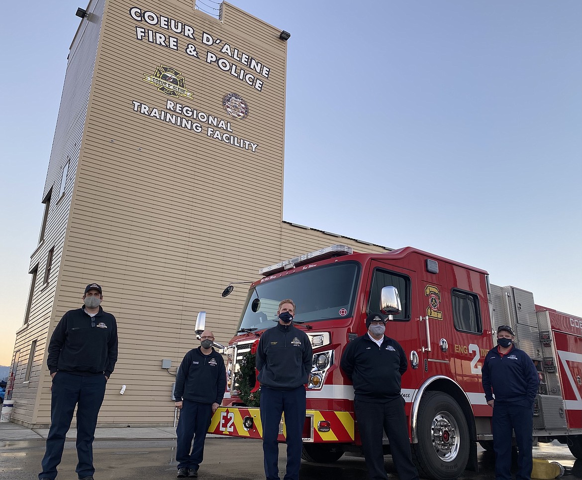 Six feet apart isn't just a guidance at the Coeur d'Alene Fire Department but an obligation. Since the initial hit of COVID-19 the service organization has adopted multiple precautions to ensure the safety of not only their personnel but the entire community. Here, a handful of first responders and administration stand at a distance in front of a department engine. From left: CDAFD Battalion Chief John Morrison, firefighter and paramedic Scott Dietrich, firefighter and paramedic Eric Loney, Deputy Chief Tom Greif, and PIO Craig Atherton. (MADISON HARDY/Press)