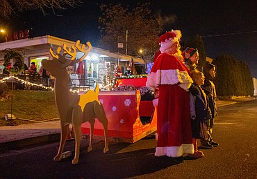 Kent and Kim Bacon of Quincy provided Mrs. Claus and Santa with their sleigh on Friday night for the drive-thru lights event.