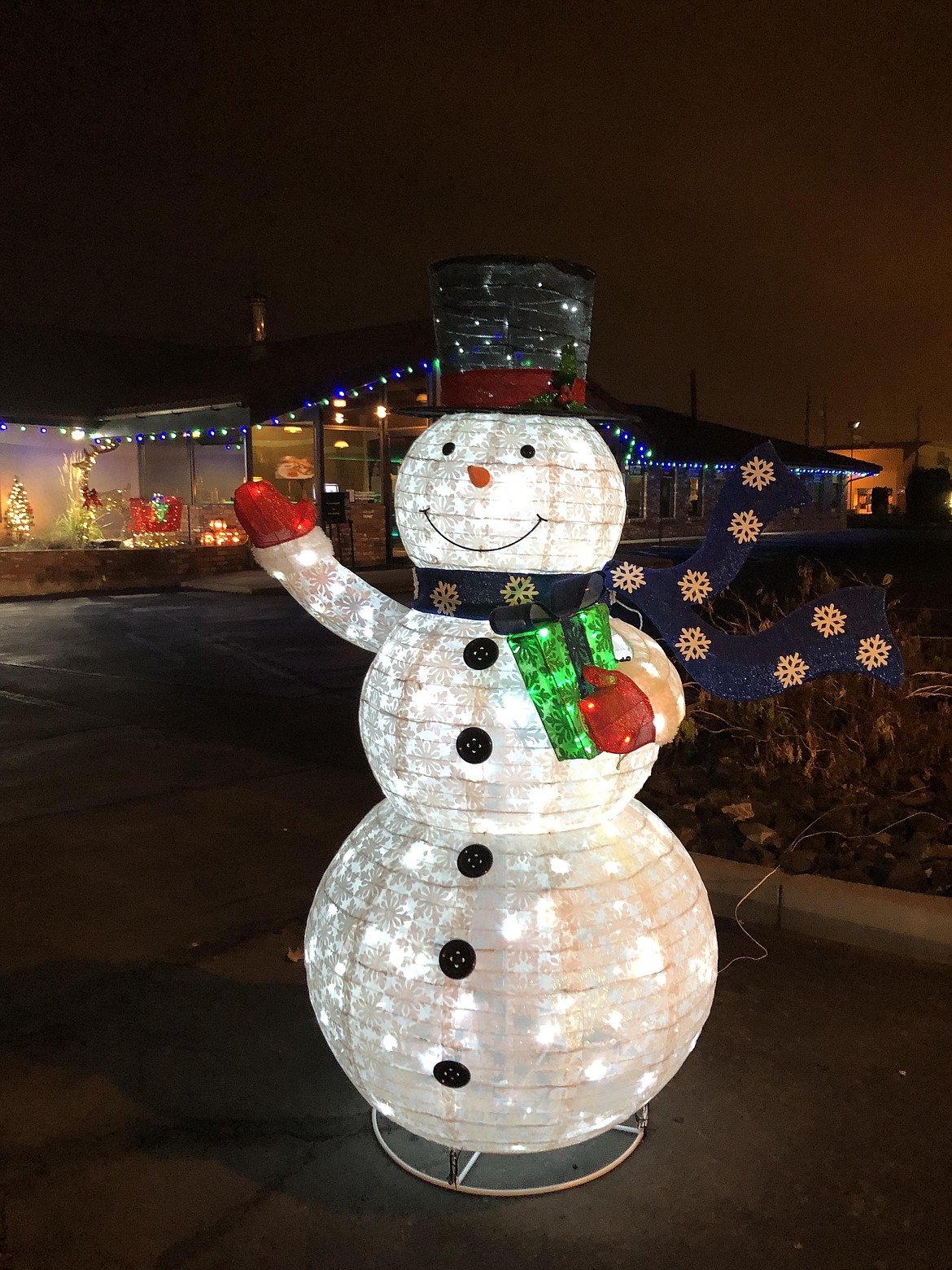 An inflatable snowman in front of the LocalTel on Broadway, one of 10 businesses that entered the Light Up Moses Lake contest on Friday.