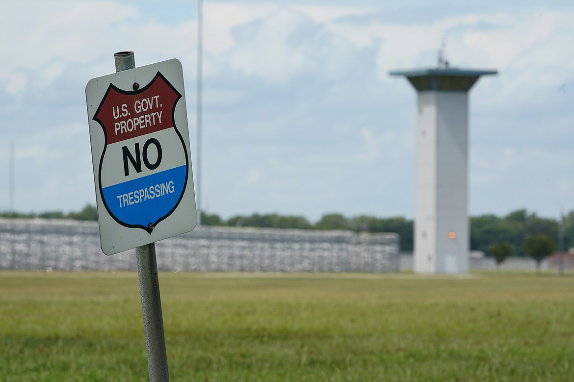 In this Aug. 28, 2020, file photo, a no trespassing sign is displayed outside the federal prison complex in Terre Haute, Ind. As Donald Trump’s presidency winds down, his administration is throttling up the pace of federal executions despite a surge of COVID-19 cases in prison, announcing plans for five executions just days before the Jan. 20 inauguration of death penalty foe Joe Biden. Attorney General William Barr defends the action in an interview with The Associated Press and says he will likely schedule additional executions before leaving the Cabinet.