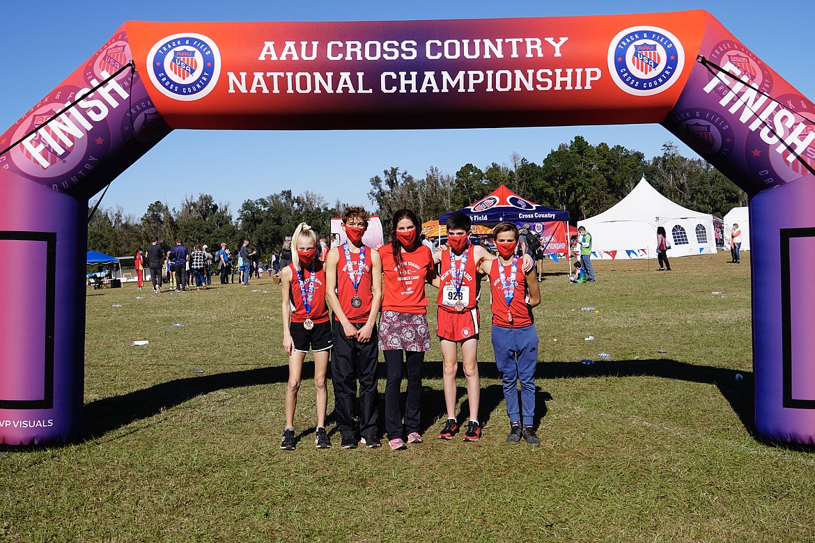 Courtesy photo
Four members of the North Idaho Cross Country team earned All-American patches for placing in the top 8 in their age group at the AAU National Cross Country Championships on Dec. 5 in Tallahassee, Fla. From left are Adalyn Depew, Max Cervi-Skinner, coach Erin Lydon Hart, Wyatt Carr and Mitchell Rietze.