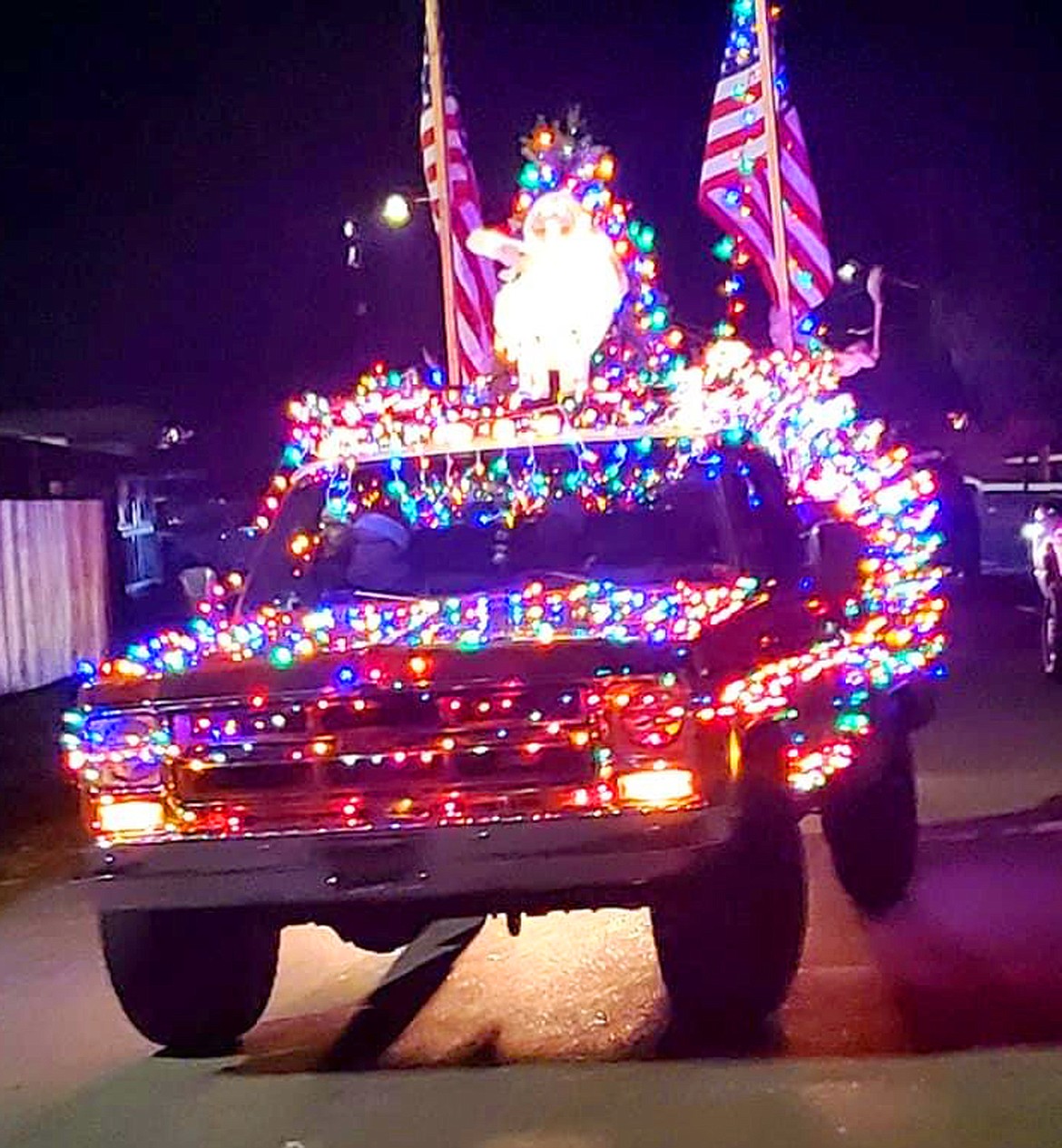 One of nearly 50 entries in Rathdrum's Christmas parade drives on the route around town Saturday.