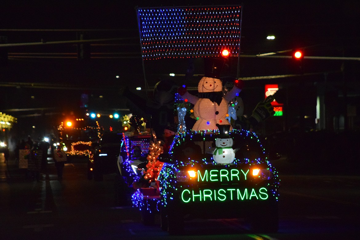 The float carrying Othello's own "Seahawk Santa," Roger Ensz, comes down Main Street during the Christmas Miracle on Main Street Parade in Othello last Saturday.