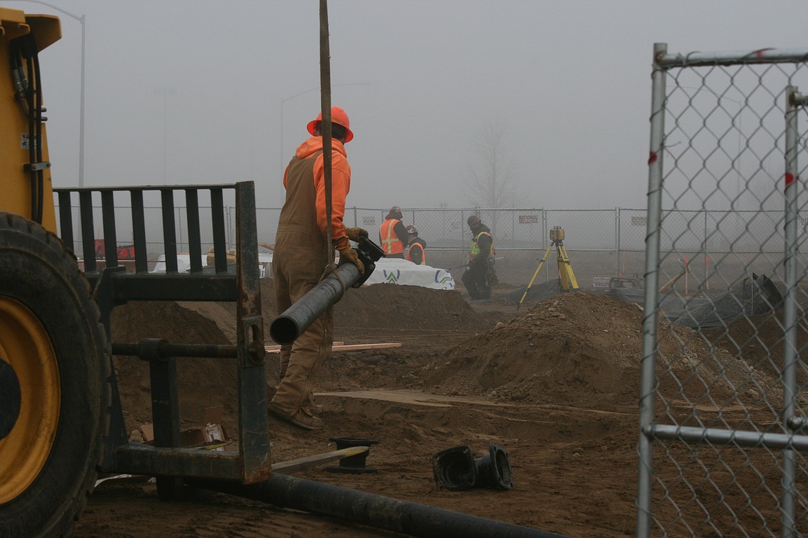 Construction work has begun on a new Confluence Health facility on Yonezawa Boulevard in Moses Lake. Kevin Myre, building official for Moses Lake, said a building permit for the 7,000-square-foot facility was issued Dec. 2. 
Crews have started working on the foundation. Above, Conner Beckwith moves lengths of pipe at the site Wednesday afternoon.