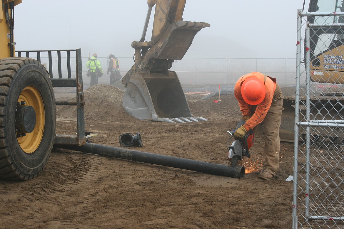 Construction work has begun on a new Confluence Health facility on Yonezawa Boulevard in Moses Lake. Kevin Myre, building official for Moses Lake, said a building permit for the 7,000-square-foot facility was issued Dec. 2. 
Crews have started working on the foundation. Above, Conner Beckwith cuts lengths of pipe at the site Wednesday afternoon.