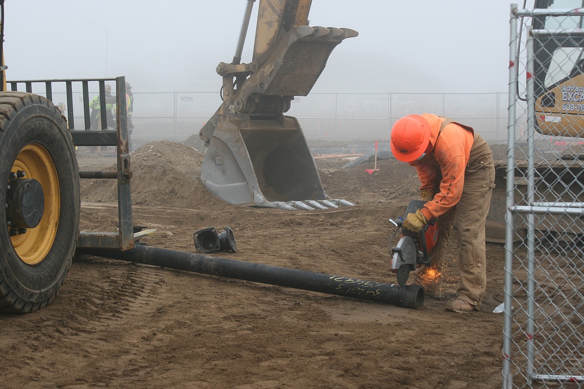 Construction work has begun on a new Confluence Health facility on Yonezawa Boulevard in Moses Lake. Kevin Myre, building official for Moses Lake, said a building permit for the 7,000-square-foot facility was issued Dec. 2. 
Crews have started working on the foundation. Above, Conner Beckwith cuts lengths of pipe at the site Wednesday afternoon.