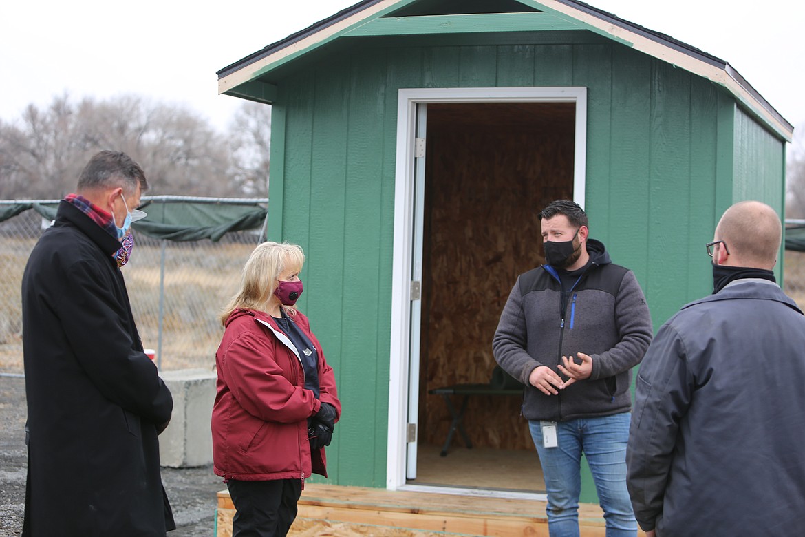 From left to right, Moses Lake Mayor David Curnel, council member Karen Liebrecht, Housing and Grants Coordinator Taylor Burton and council member Don Myers (with others) meet at the city’s new sleeping center Thursday, touring the site and taking a last look before it was to open Friday night.