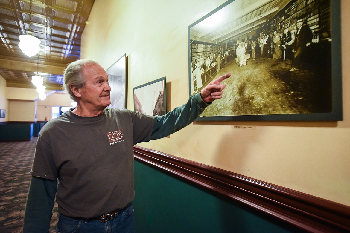 Bill Goodman points to a picture of the former Red's Wines & Blues establishment, which is now Split Rock Cafe, inside the KM Building in Kalispell on Friday, Dec. 4. (Casey Kreider/Daily Inter Lake)