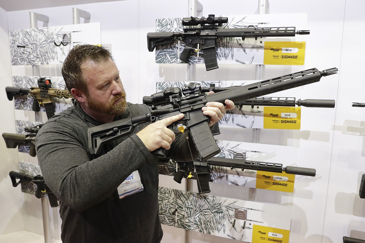 Bryan Oberc, Munster, Ind., tries out an AR-15 from Sig Sauer in the exhibition hall at the National Rifle Association Annual Meeting in Indianapolis, Saturday, April 27, 2019. Efforts to impose restrictions on firearms will soon have a supporter in the White House. But it's unlikely that big ticket items gun-control advocates have pined for will have much chance of passage given the tight margins in Congress and the increased polarization over gun issues. Much has changed in the past 12 years: more Americans own firearms and there are more AR-platform firearms in the civilian market.